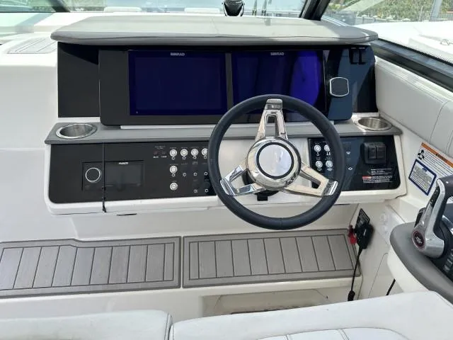  Yacht Photos Pics Cockpit of 2022 Sea Ray Sundancer 320 with modern steering and control panels.