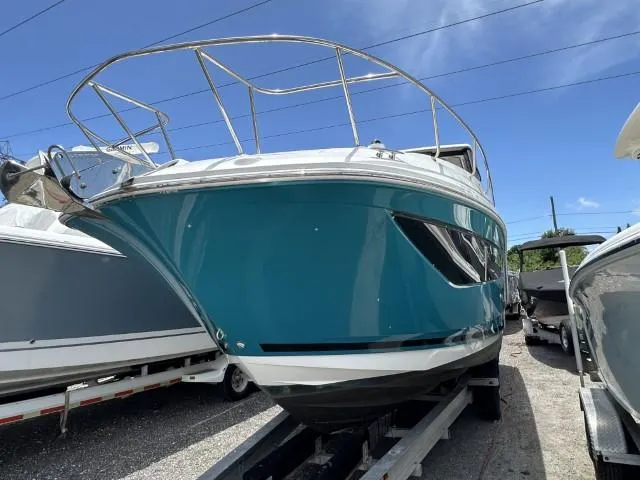  Yacht Photos Pics 2022 Sea Ray Sundancer 320 boat on trailer, vibrant blue hull, sunny day.