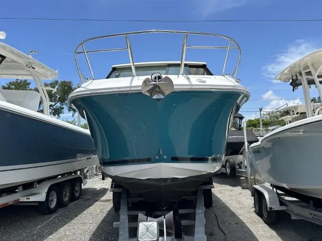 Yacht Photos Pics 2022 Sea Ray Sundancer 320 boat on trailer, front view, blue hull, sunny day.