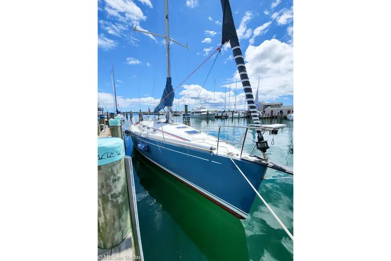  Yacht Photos Pics 2005 Beneteau First 44.7 sailboat docked in a sunny marina.