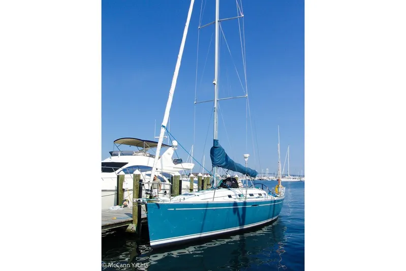  Yacht Photos Pics 2005 Beneteau First 44.7 sailboat docked at marina under clear blue sky.