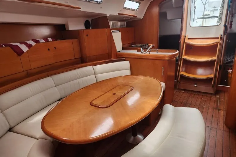  Yacht Photos Pics Luxurious interior of 2005 Beneteau First 44.7 yacht with wooden furnishings and cozy seating.