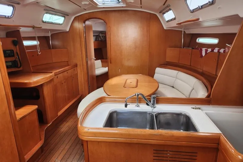  Yacht Photos Pics Interior of 2005 Beneteau First 44.7 yacht with wood finish and modern amenities.