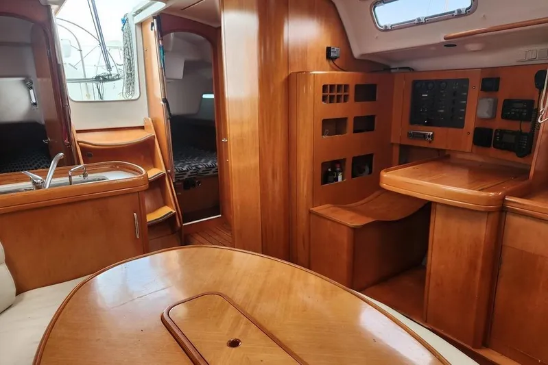  Yacht Photos Pics Interior of 2005 Beneteau First 44.7 yacht with wood finish and navigation station.