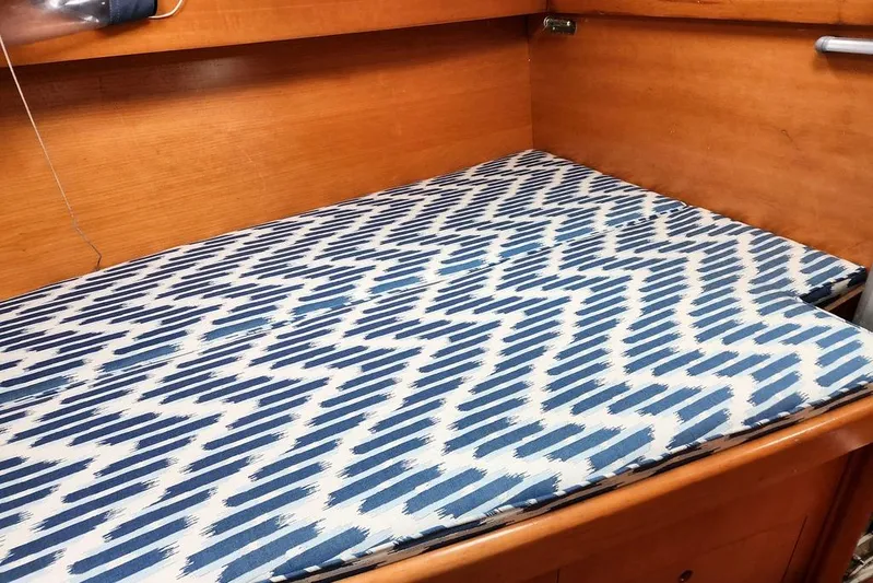  Yacht Photos Pics Cushioned bed in 2005 Beneteau First 44.7 yacht with blue patterned fabric.