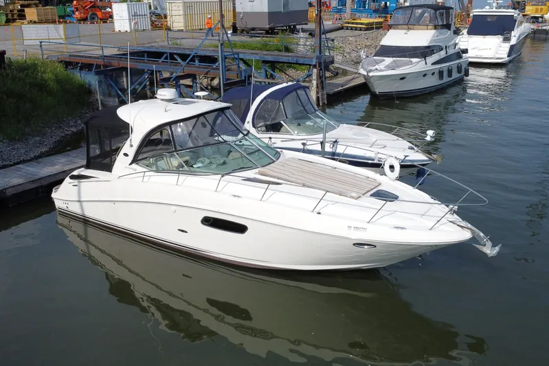 Yacht Photos Pics 2012 Sea Ray 370 Sundancer yacht docked at marina, surrounded by other boats.