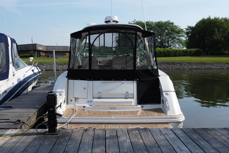  Yacht Photos Pics 2012 Sea Ray 370 Sundancer docked at a marina, rear view.