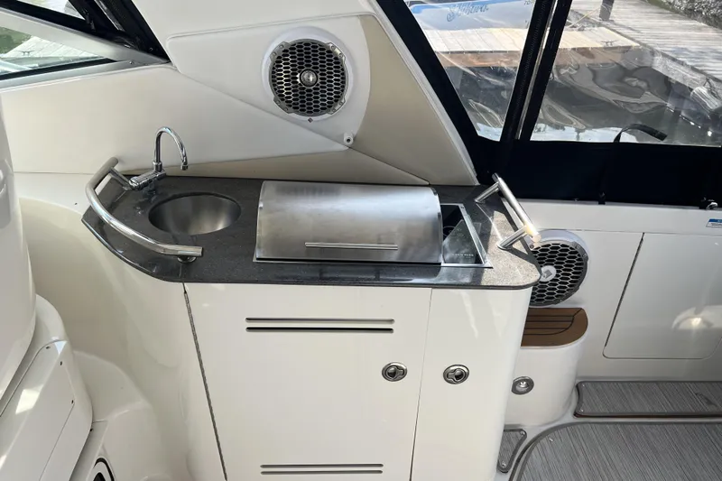  Yacht Photos Pics 2012 Sea Ray 370 Sundancer yacht kitchenette with sink, grill, and speaker.