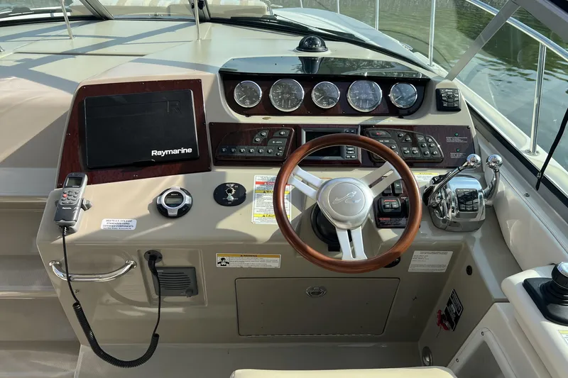 Yacht Photos Pics Cockpit of 2012 Sea Ray 370 Sundancer with steering wheel and navigation controls.
