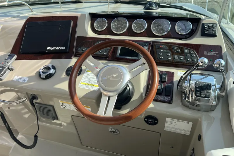  Yacht Photos Pics Cockpit of 2012 Sea Ray 370 Sundancer with Raymarine navigation and wooden steering wheel.