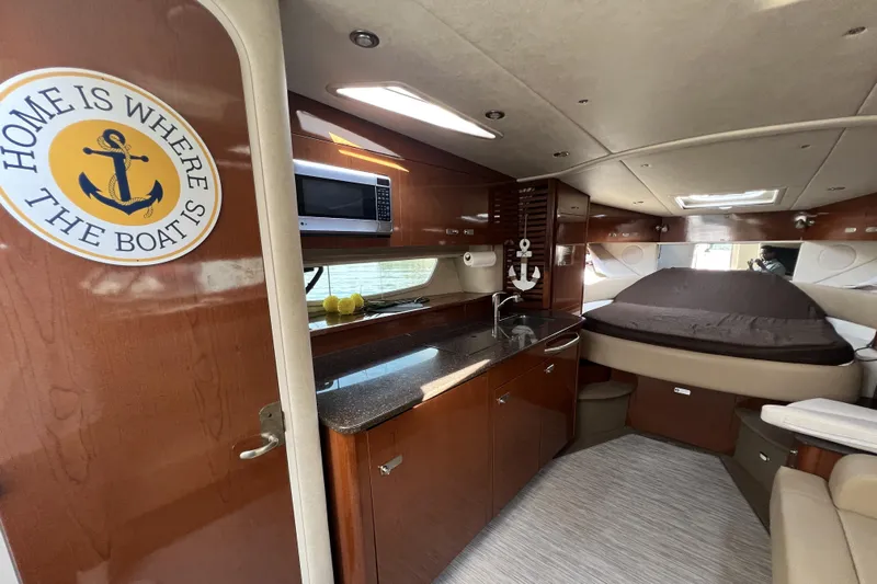  Yacht Photos Pics Interior of 2012 Sea Ray 370 Sundancer yacht with kitchen and bed area.