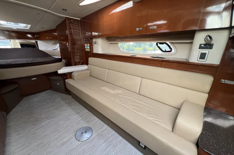  Yacht Photos Pics Luxurious interior of 2012 Sea Ray 370 Sundancer yacht with beige seating and wood finishes.