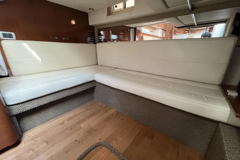  Yacht Photos Pics Interior of 2012 Sea Ray 370 Sundancer with cream leather seating and wooden flooring.