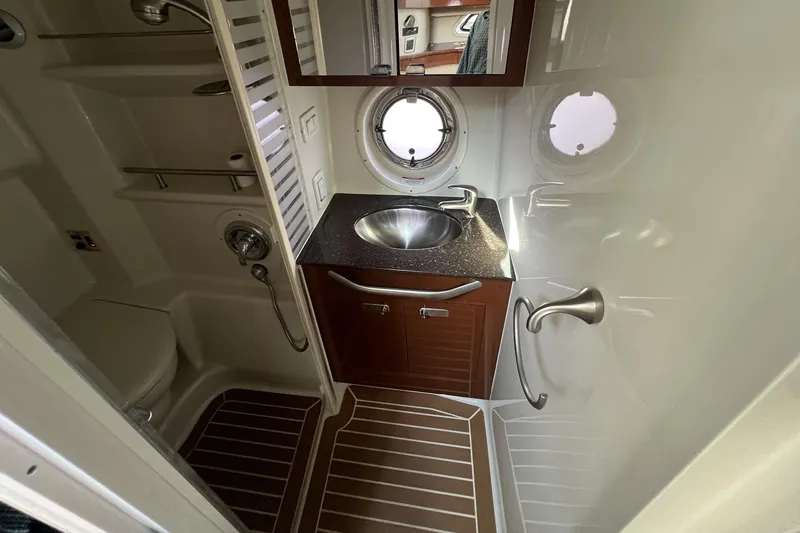  Yacht Photos Pics Bathroom interior of 2012 Sea Ray 370 Sundancer yacht with sink and porthole.