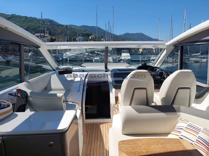  Yacht Photos Pics Luxurious 2020 Princess V50 yacht interior with modern seating and scenic marina view.