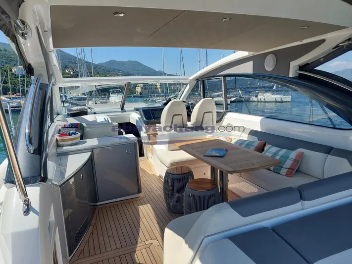  Yacht Photos Pics Luxurious 2020 Princess V50 yacht interior with seating, table, and scenic marina view.