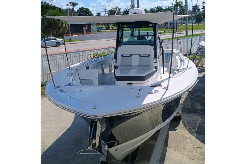 332-299 Yacht Photos Pics 2025 Blackfin 332 CC boat with sleek design and spacious deck, docked outdoors.