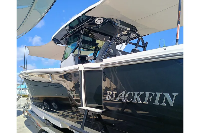 332-299 Yacht Photos Pics 2025 Blackfin 332 CC boat with sleek black exterior and modern design.