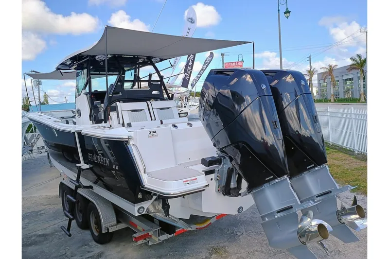 332-299 Yacht Photos Pics 2025 Blackfin 332 CC boat with dual engines on a trailer, under a clear sky.