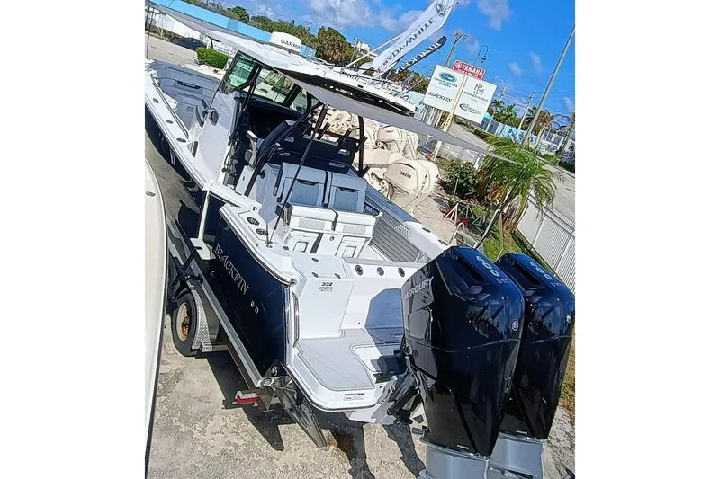 332-299 Yacht Photos Pics 2025 Blackfin 332 CC boat with dual Mercury engines, docked outdoors.