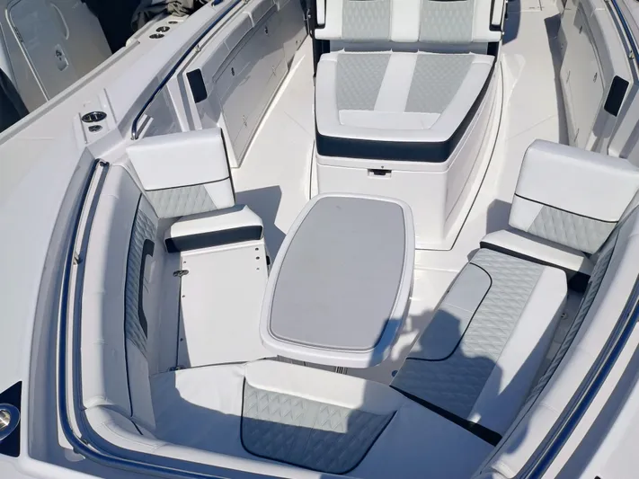 332-299 Yacht Photos Pics 2025 Blackfin 332 CC boat interior with white seating and table.