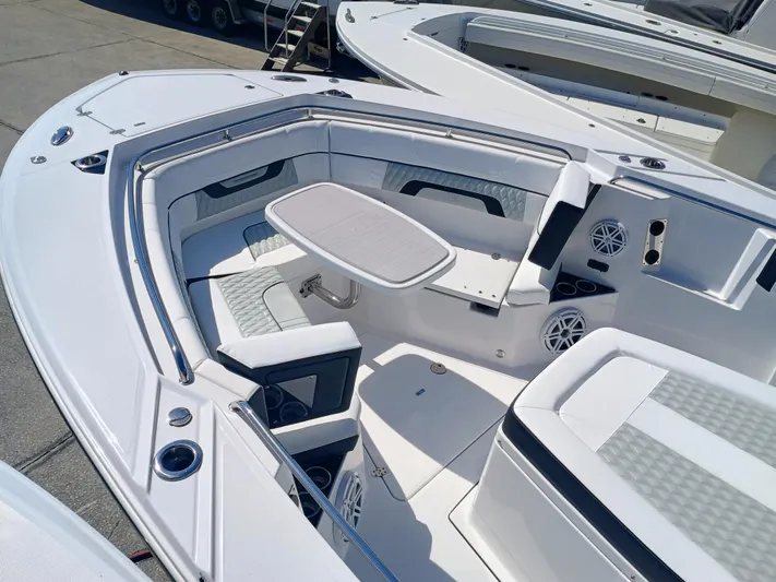 332-299 Yacht Photos Pics 2025 Blackfin 332 CC boat interior with seating and table, showcasing modern design and amenities.