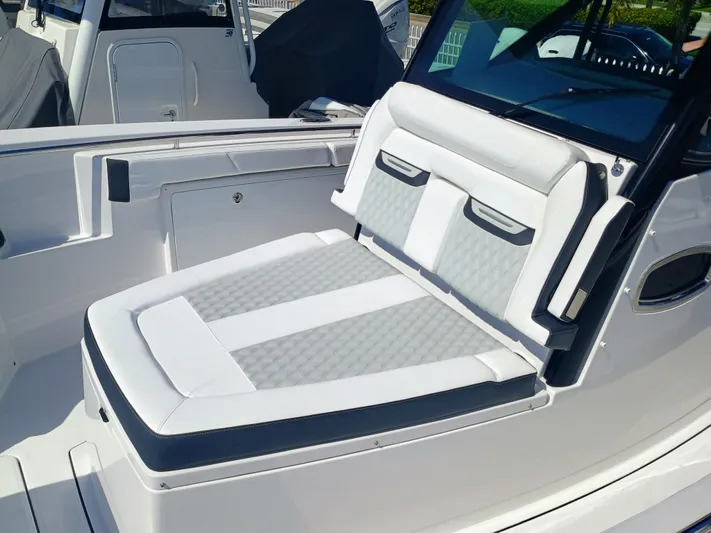 332-299 Yacht Photos Pics 2025 Blackfin 332 CC boat interior with cushioned seating and sleek design.