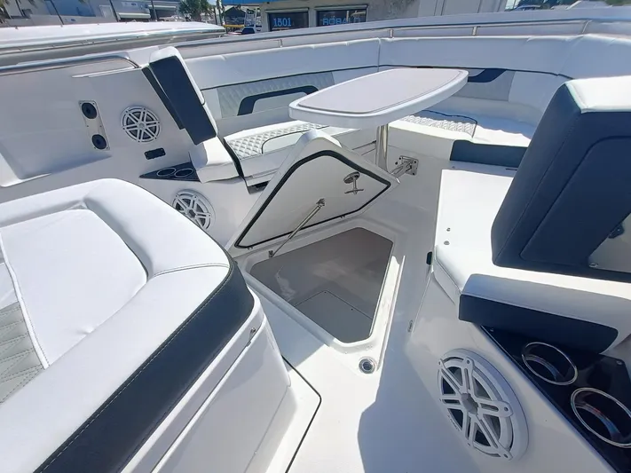 332-299 Yacht Photos Pics 2025 Blackfin 332 CC boat interior with seating, storage, and table.