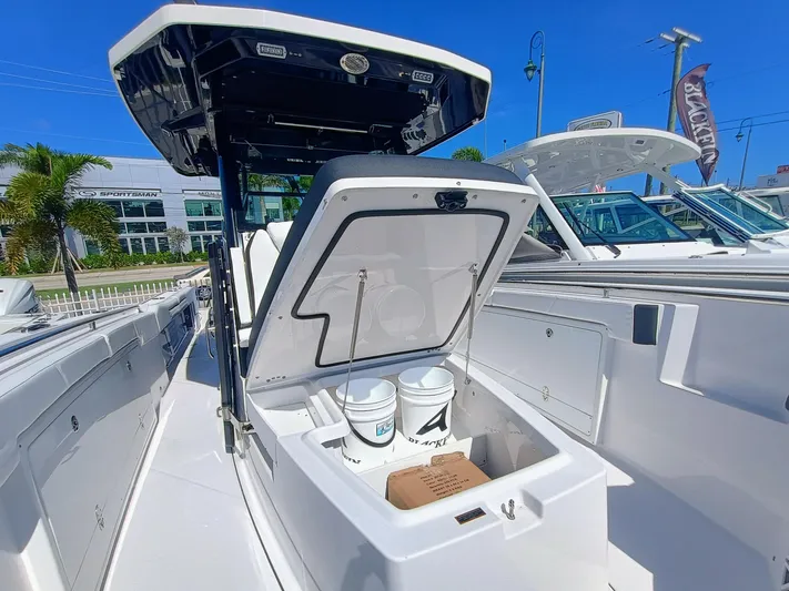 332-299 Yacht Photos Pics 2025 Blackfin 332 CC boat with open storage compartment, showcasing interior features.