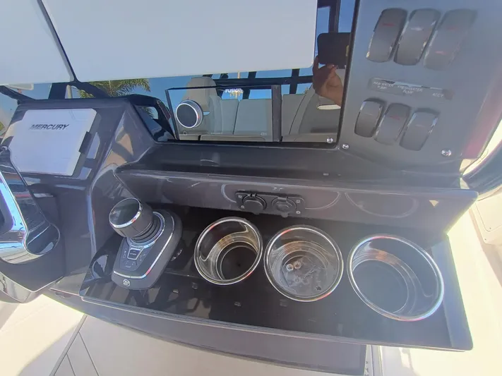 332-299 Yacht Photos Pics 2025 Blackfin 332 CC boat console with Mercury controls and cup holders.