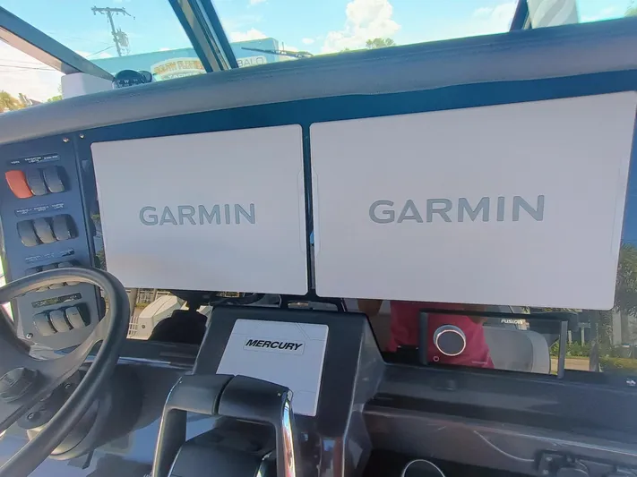 332-299 Yacht Photos Pics Dashboard of 2025 Blackfin 332 CC with dual Garmin displays and Mercury controls.