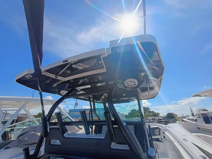 332-299 Yacht Photos Pics 2025 Blackfin 332 CC boat with sunlit hardtop and clear blue sky.