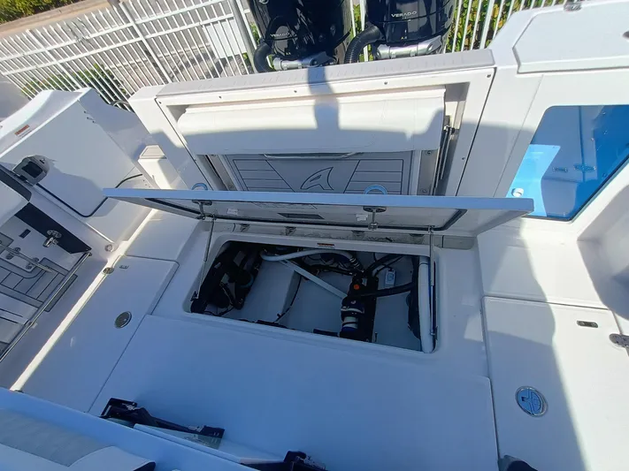332-299 Yacht Photos Pics 2025 Blackfin 332 CC boat with open storage compartment, showcasing interior features.