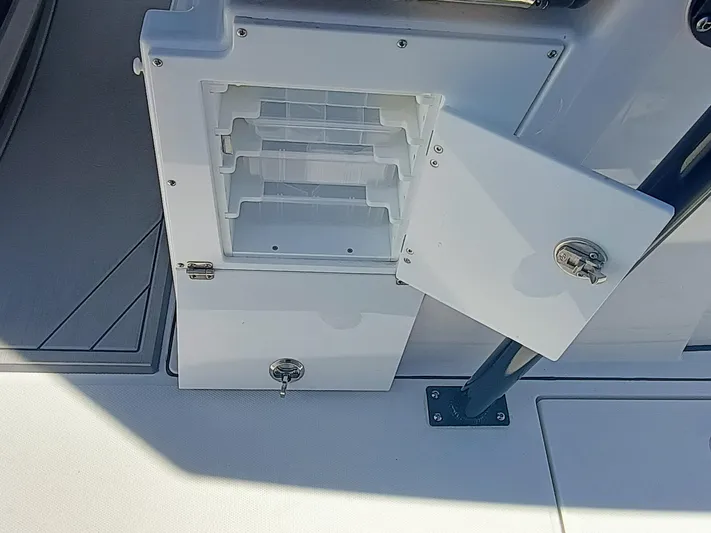 332-299 Yacht Photos Pics 2025 Blackfin 332 CC boat storage compartment with open door and secure latch.