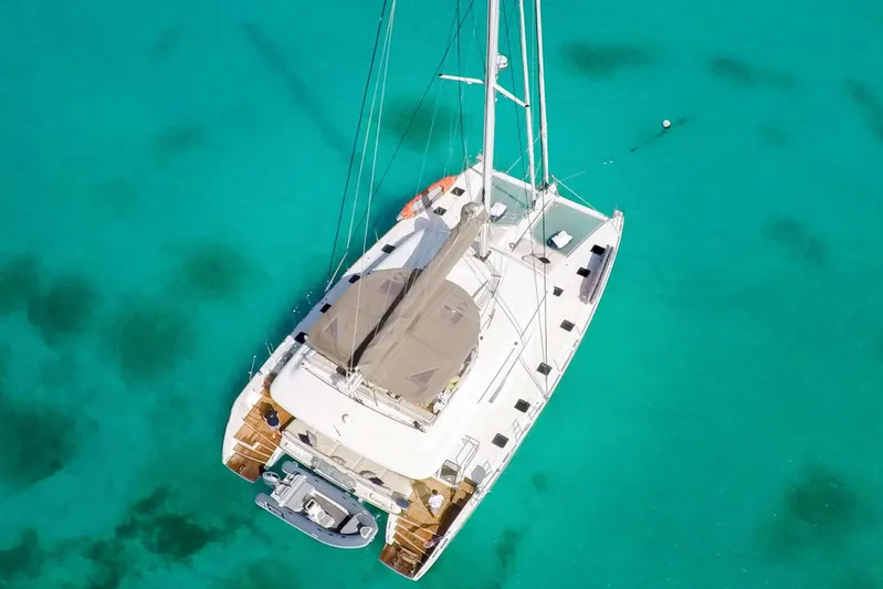  Yacht Photos Pics Aerial view of 2018 Lagoon 620 catamaran on turquoise water.
