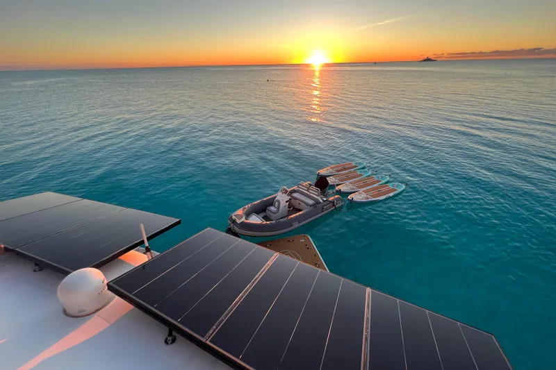  Yacht Photos Pics Lagoon 620 yacht with solar panels at sunset, 2018 model, serene ocean view.