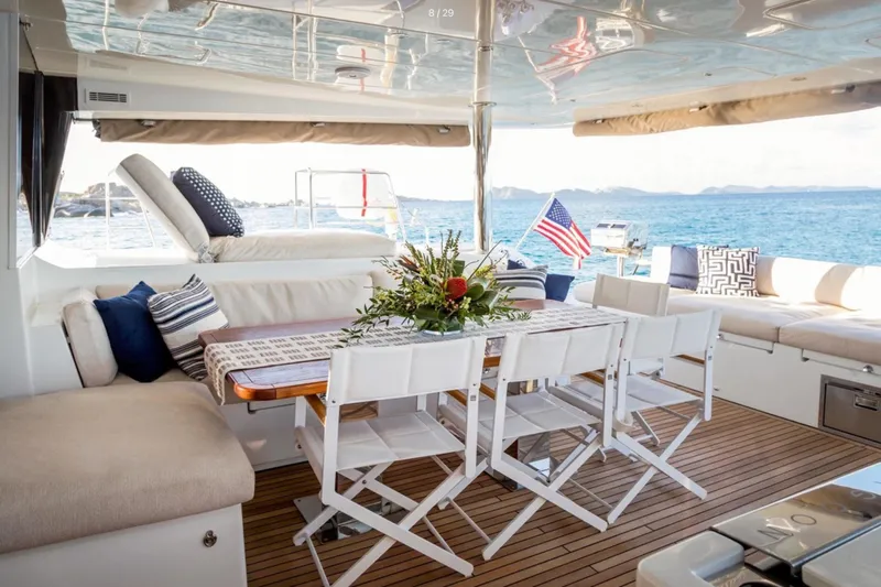  Yacht Photos Pics Luxurious Lagoon 620 yacht deck with dining area, cushions, and ocean view, 2018 model.