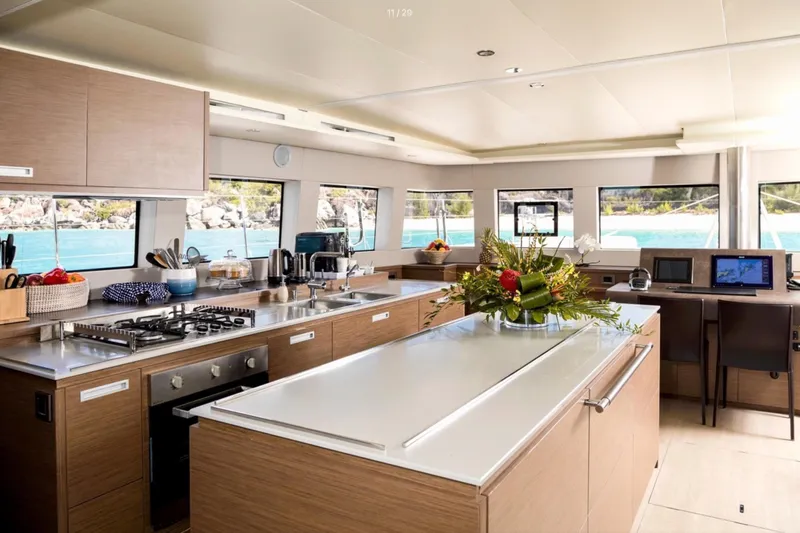  Yacht Photos Pics Luxurious interior of 2018 Lagoon 620 yacht with modern kitchen and ocean view.