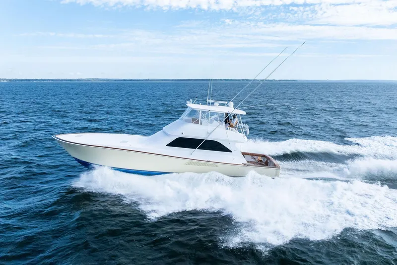 Bait Waster Yacht Photos Pics 2001 Viking 61 yacht cruising on open sea under clear sky.