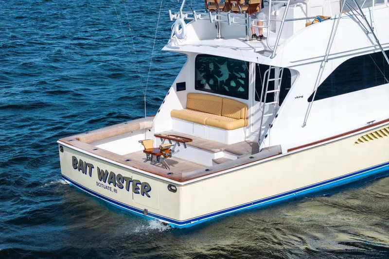 Bait Waster Yacht Photos Pics 2001 Viking 61 yacht "Bait Waster" cruising on open water, featuring a spacious deck.