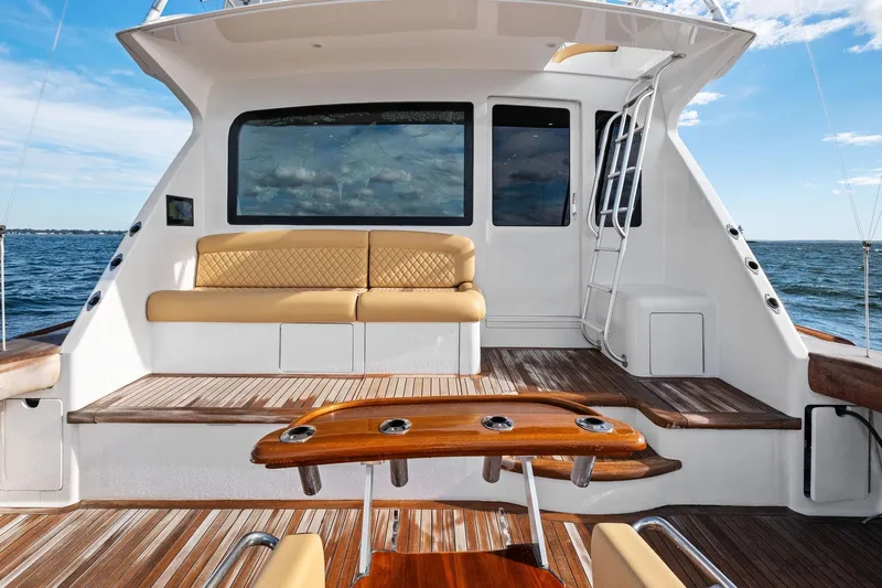 Bait Waster Yacht Photos Pics Luxurious 2001 Viking 61 yacht deck with seating, ocean view, and wooden accents.