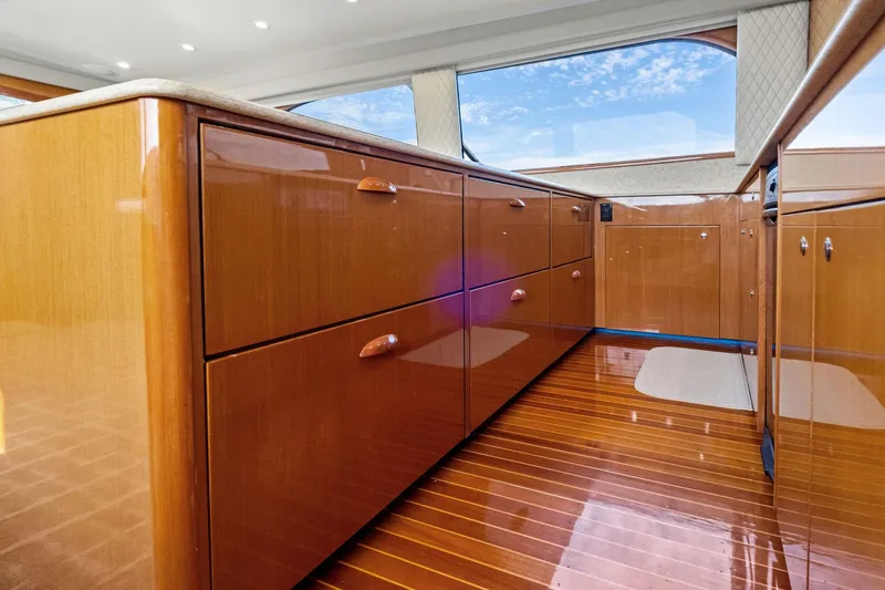 Bait Waster Yacht Photos Pics Luxurious wooden interior of a 2001 Viking 61 yacht, featuring polished cabinets and flooring.