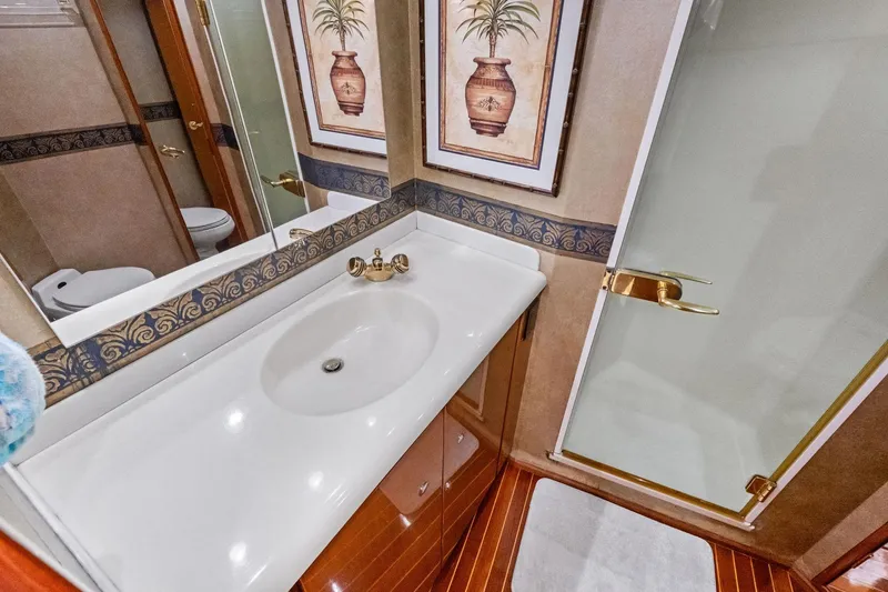 Bait Waster Yacht Photos Pics Luxurious bathroom in 2001 Viking 61 yacht with elegant decor and modern fixtures.