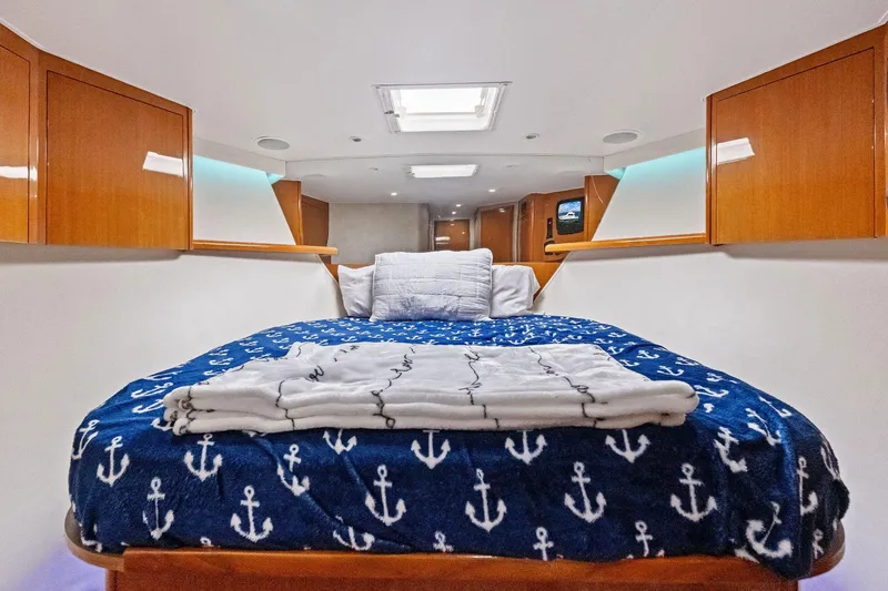 Bait Waster Yacht Photos Pics Luxurious cabin interior of 2001 Viking 61 yacht with anchor-themed bedding.