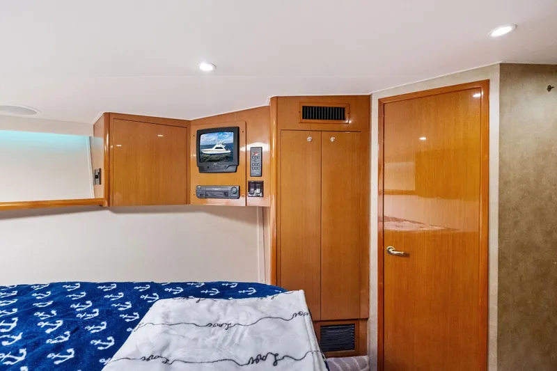 Bait Waster Yacht Photos Pics Interior of 2001 Viking 61 yacht cabin with wood paneling and TV.