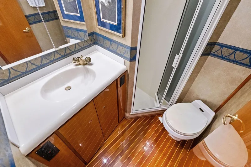 Bait Waster Yacht Photos Pics Luxurious bathroom in 2001 Viking 61 yacht with shower, sink, and toilet.