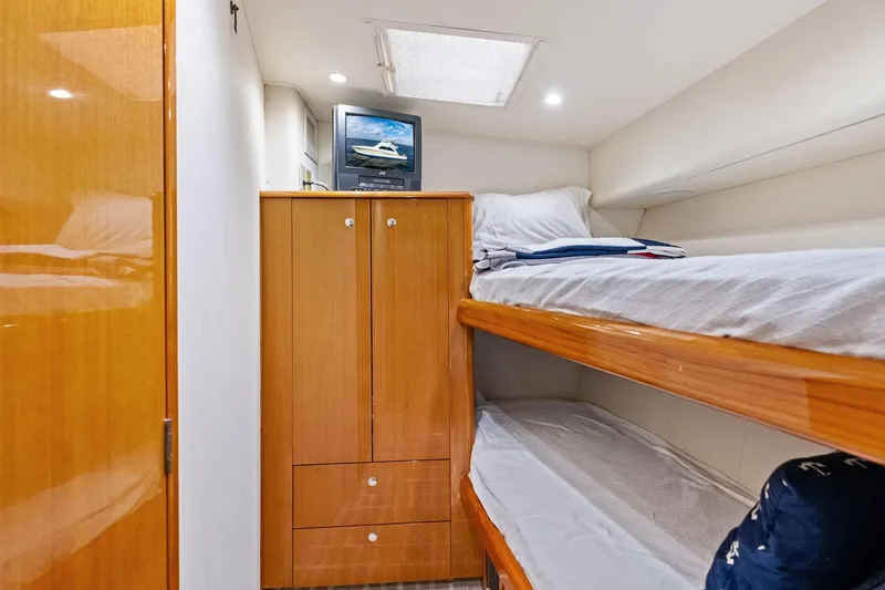Bait Waster Yacht Photos Pics Interior of 2001 Viking 61 yacht with bunk beds and wooden cabinetry.