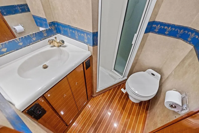 Bait Waster Yacht Photos Pics Bathroom interior of 2001 Viking 61 yacht with sink, toilet, and shower.