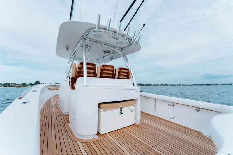 Off Course (name Reserved) Yacht Photos Pics 2018 Winter Custom Yachts 37 Custom Carolina boat with wooden deck and seating, on calm water.