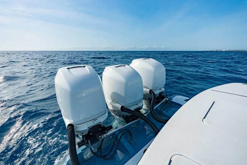 Off Course (name Reserved) Yacht Photos Pics 2018 Winter Custom Yachts 37 Custom Carolina with triple outboard engines on open sea.